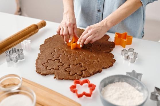 Person baking snowflake-shaped cookies