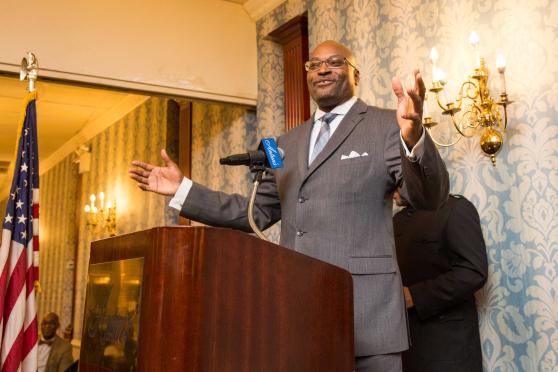 A man standing at the podium is addressing the crowd after receiving an award. 