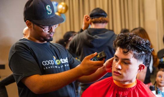 Barbering students from Manhattan’s Coop Tech demonstrate their skills with scissors and clippers.