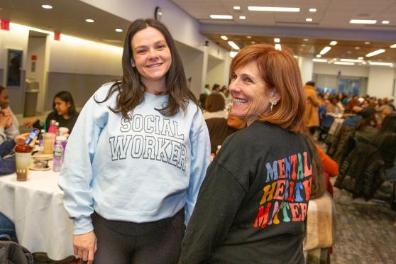 Two social workers in attendance at 2025 Clinicians Appreciation Day smile while taking a photo. 