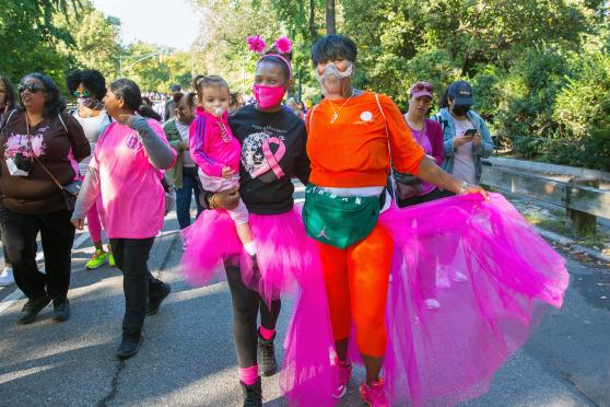 Regina Dukes (left), the paraprofessional representative at P79 in Manhattan, carries her daughter while she walks with her sister, Georgy Whitfield.