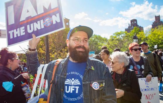 Paraprofessional Representative Jeremiah Bornemann of PS/IS 276 in Manhattan stands with fellow unionists to call for stronger labor rights at this year’s May Day rally.