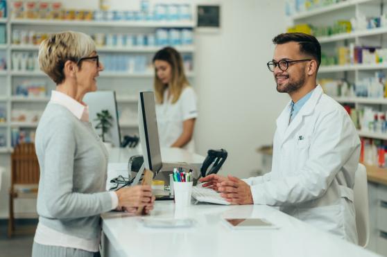 An image of a woman talking with a pharmacist.