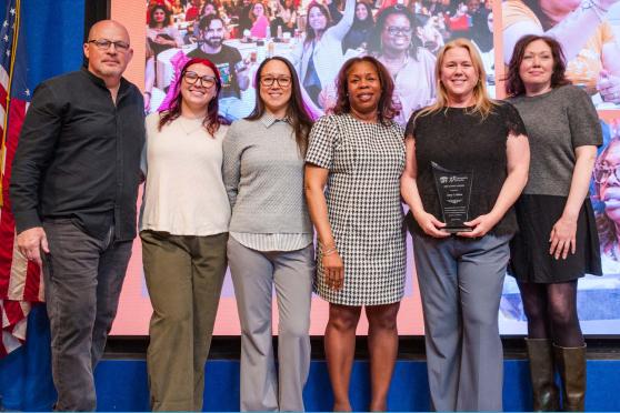 Chapter Leader Amy Craine of the Richmond Pre-K Centers (Cohort B) on Staten Island (second from right) is recognized by UFT Vice President for Elementary Schools Karen Alford (center) and UFT President Michael Mulgrew (left).