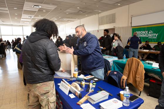 A student gets information at a table during the UFT's Future in Focus fair. 