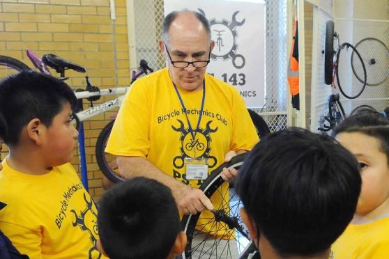 A man teaching bike repair