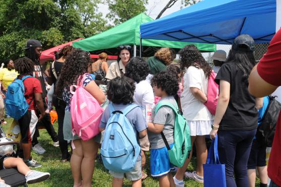 Children gather around and interact with one another while wearing new backpacks that were given away to them at the UFT's annual backpack giveaway and barbecue on Aug. 7.