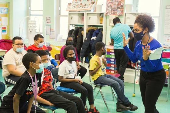 Teacher Michelle Patrovani talks to the student authors about the program, which fosters literacy and creativity.