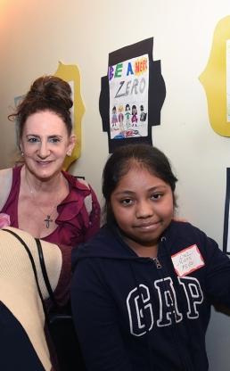 Three people standing in front of artwork