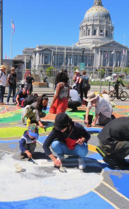 Youth drawing chalk art on ground in front of the White House