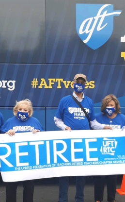 Group of activist stand in front of AFT truck 