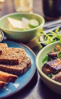 A plate of bread, veggies, cheese