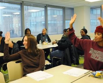 At the Manhattan conference, parent Joanne Giordano (left) is among those taking