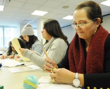 Seneida Sosa, a school counselor at MS 22 in the Bronx, crochets during a worksh