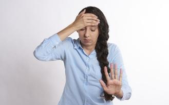 Stressed women with hand on head and gesturing stop