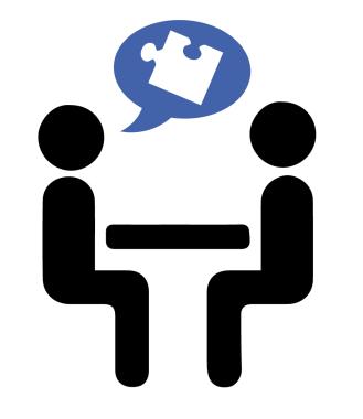 Two stick figures sitting at a table with puzzle thought bubble