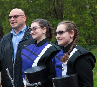 Sharon Nearby’s husband, Jeff, attends the street dedication in her memory with their daughters, Samantha and Rebecca.