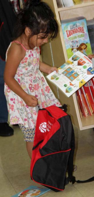 Student puts her book in her bag